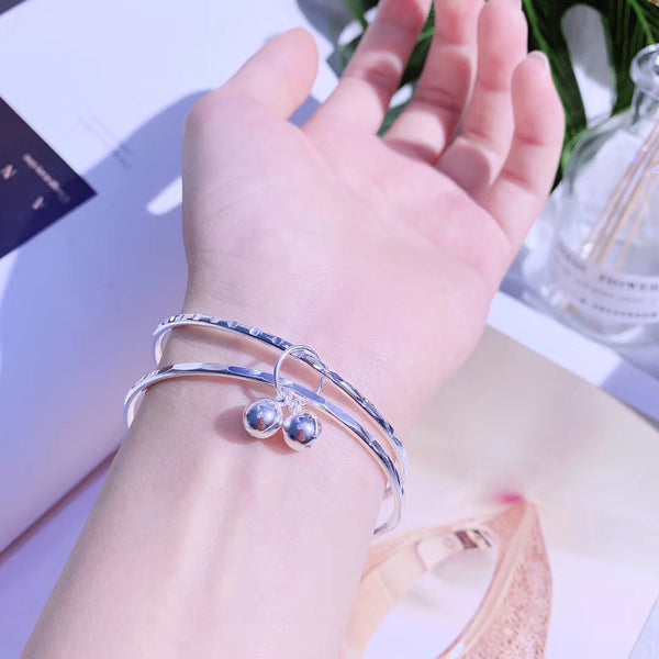 Double loop connected by bell sterling silver bracelet